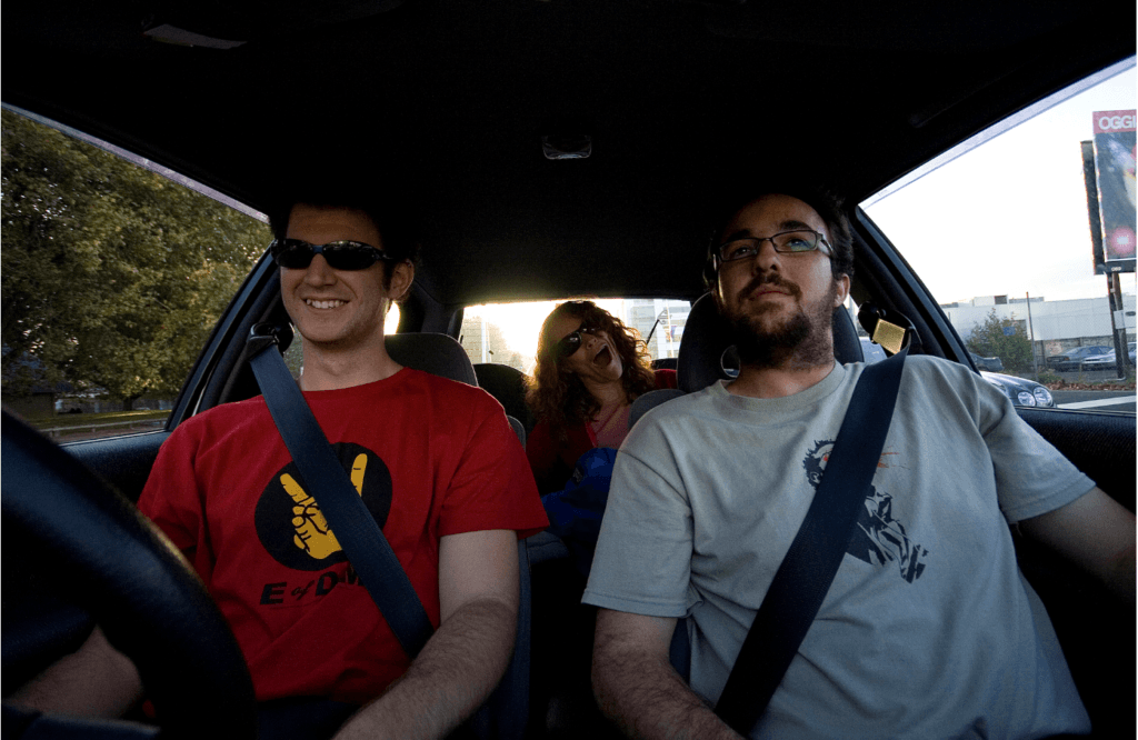 Three people smiling in car together